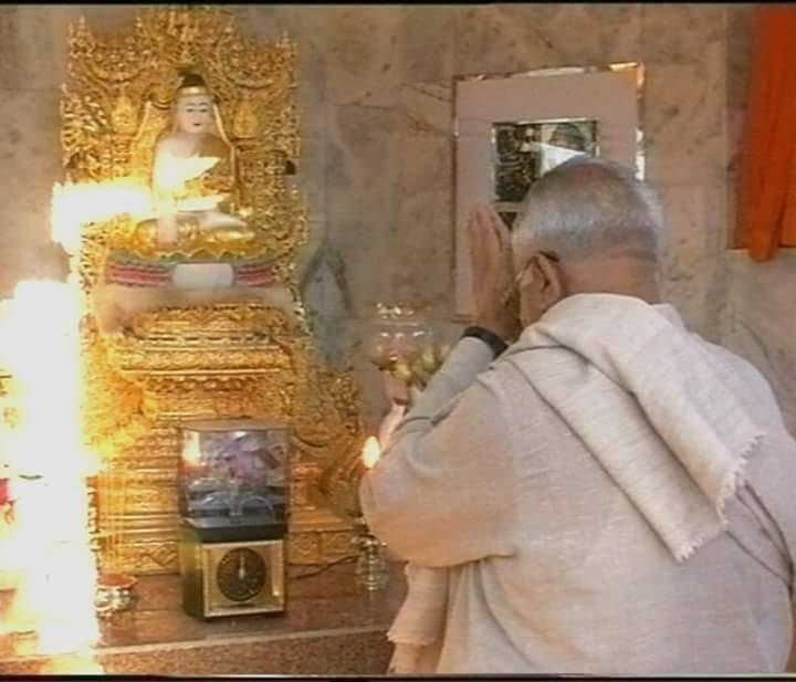 S.N. Goenka in prayer before a golden shrine